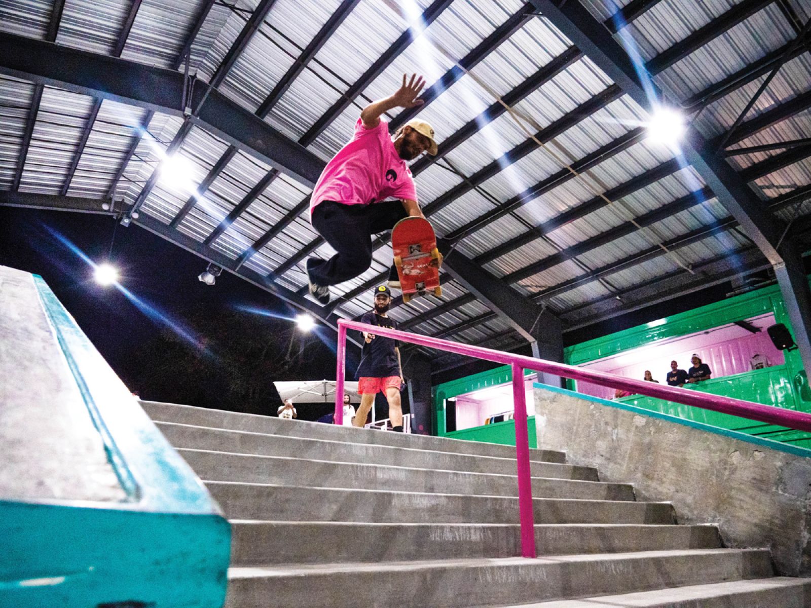 person skateboarding down rail
